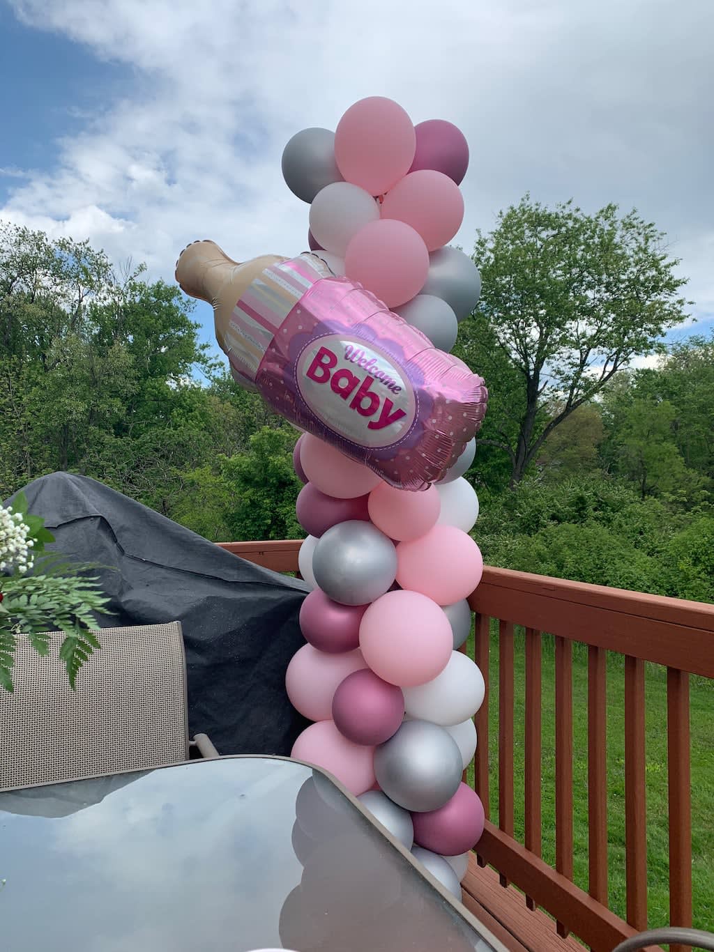 Pink and silver balloon column with a baby bottle balloon