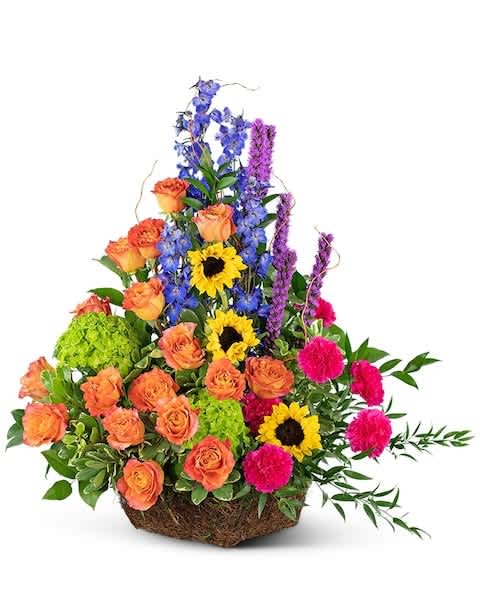 Colorful mixed flower arrangement in a woven basket