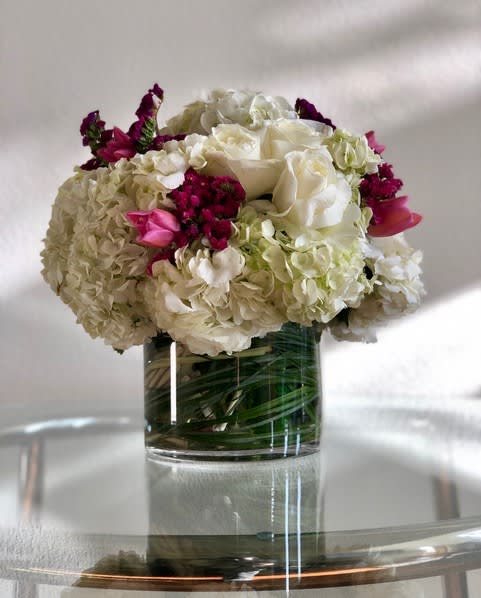 White and pink floral arrangement in a clear glass vase