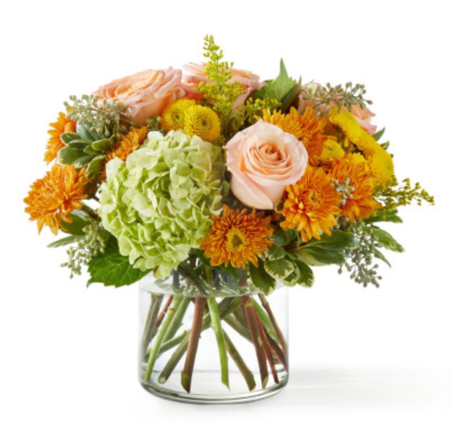 Peach roses and orange mums in a clear glass vase