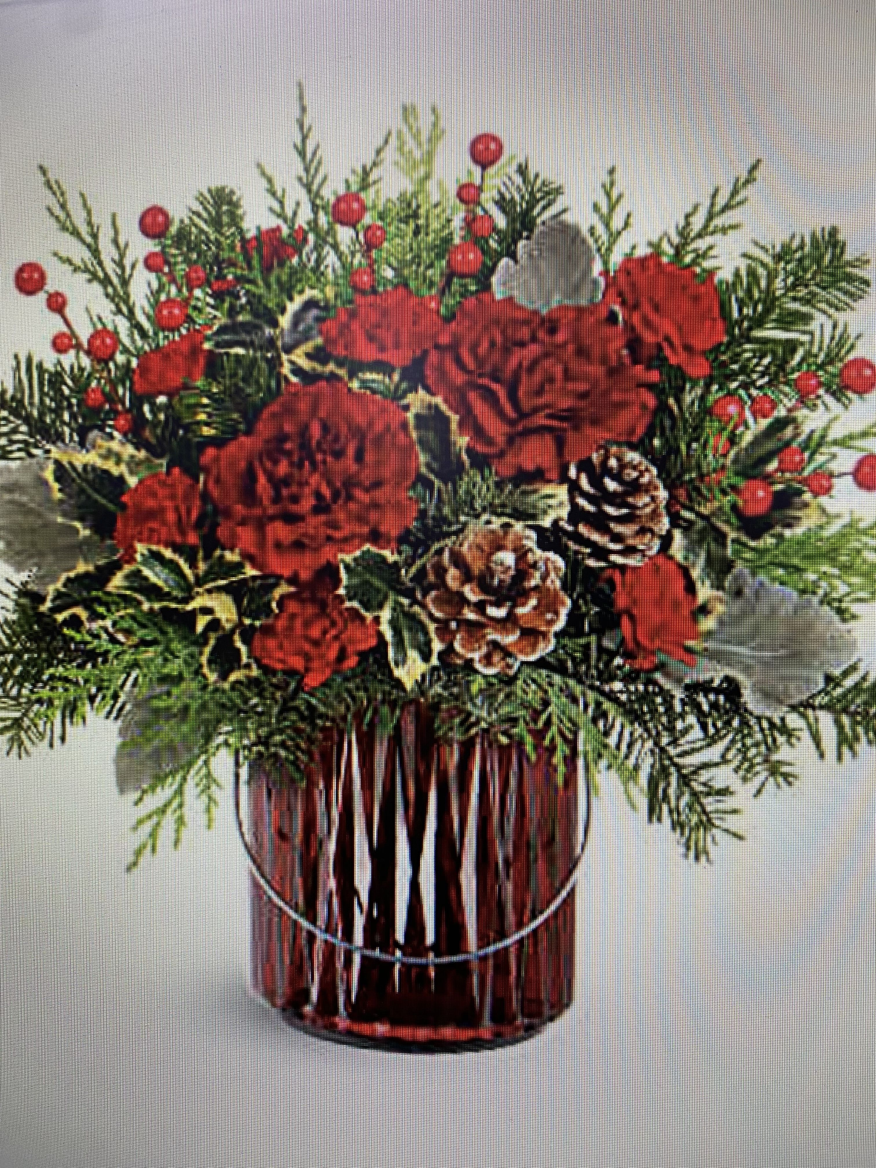 Red carnations and pinecones in a glass vase with evergreen sprigs