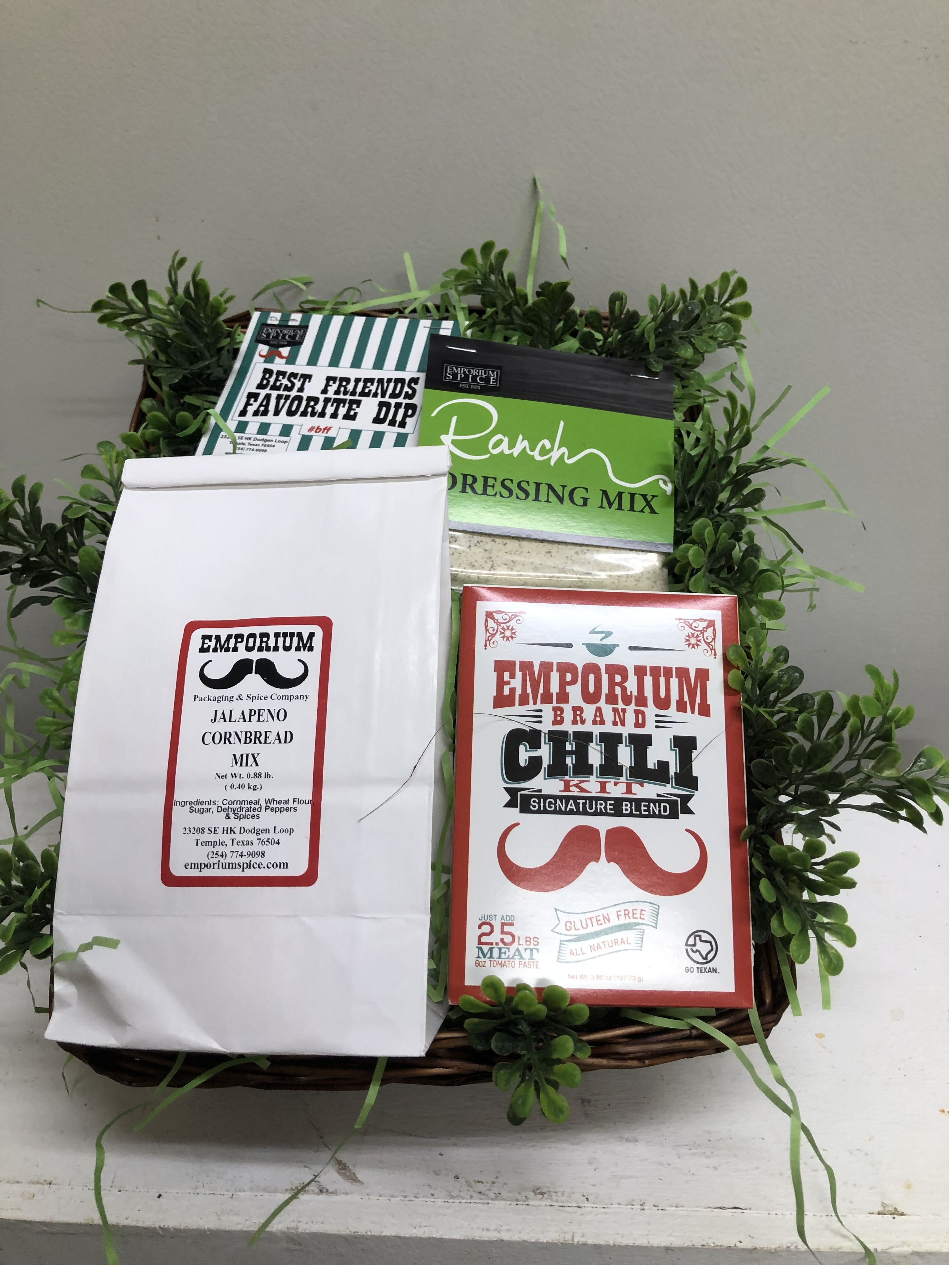 Gift basket with spice mixes and a faux greenery border