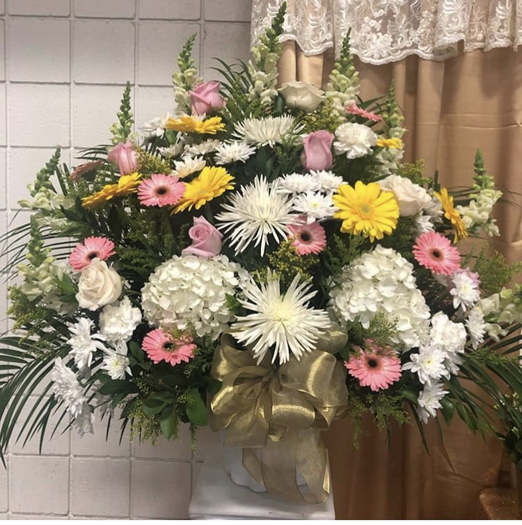Large standing floral spray with white, pink, and yellow flowers