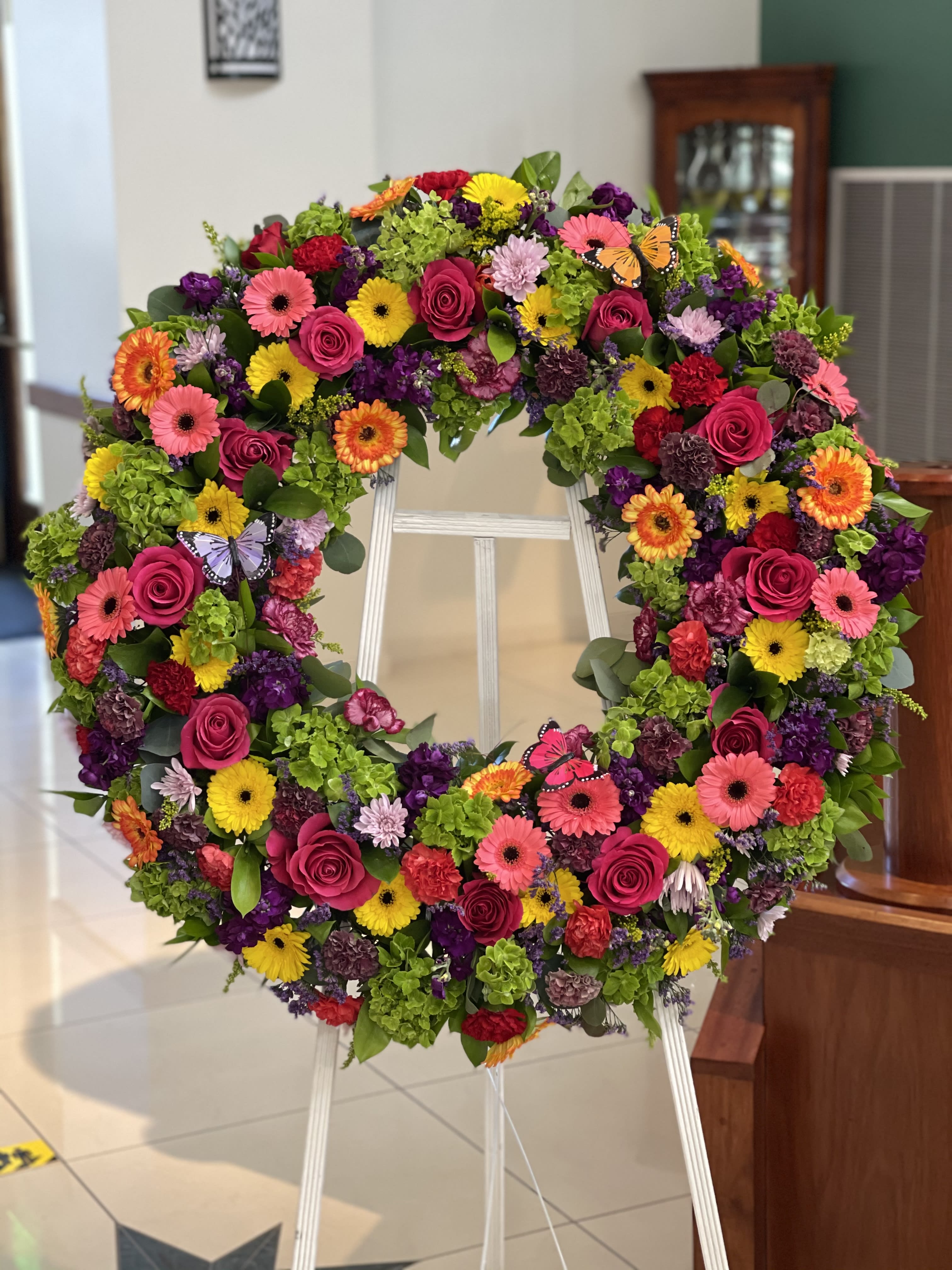 Large colorful floral wreath on a standing easel