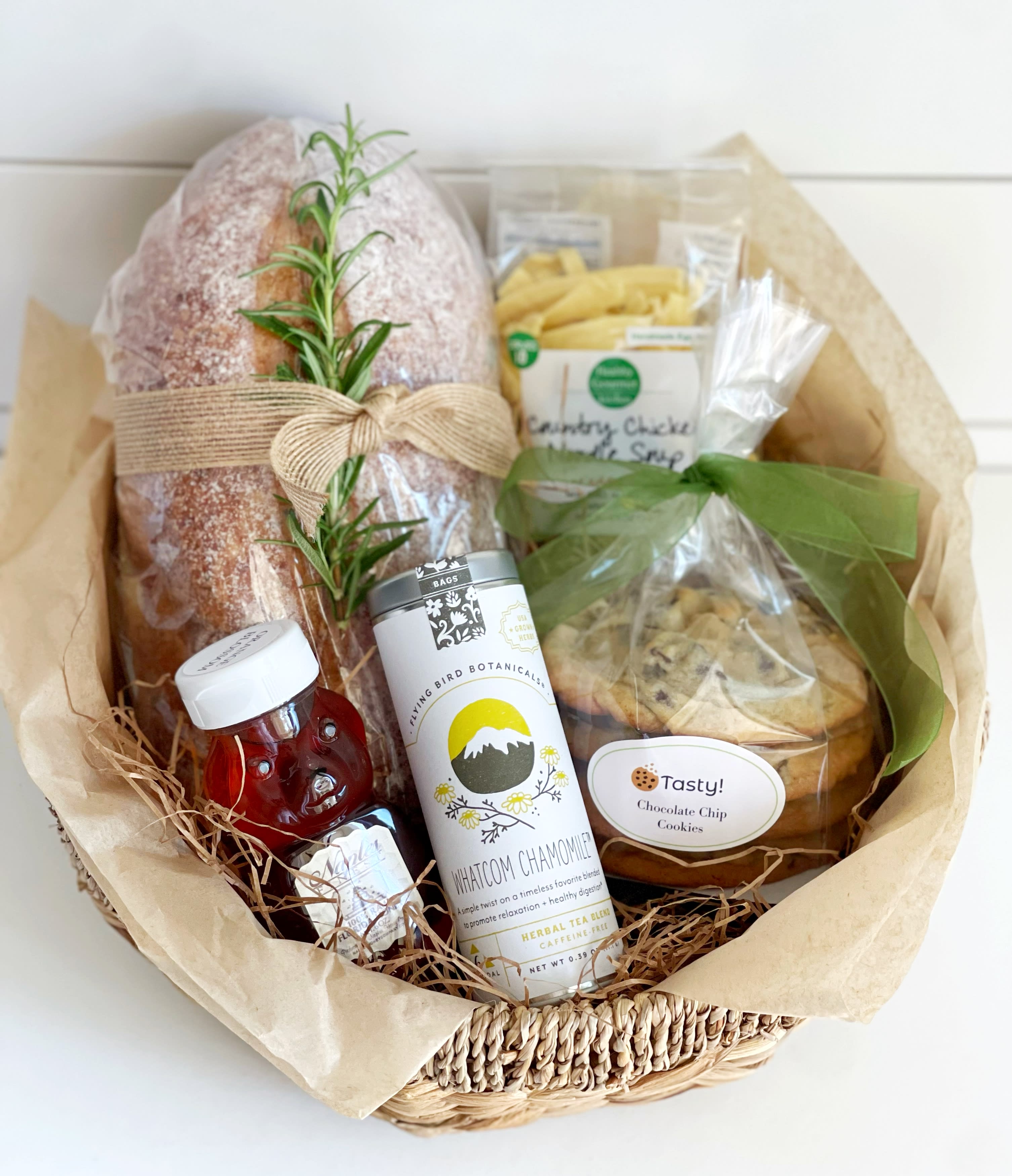 Gift basket with bread, tea, honey, and cookies