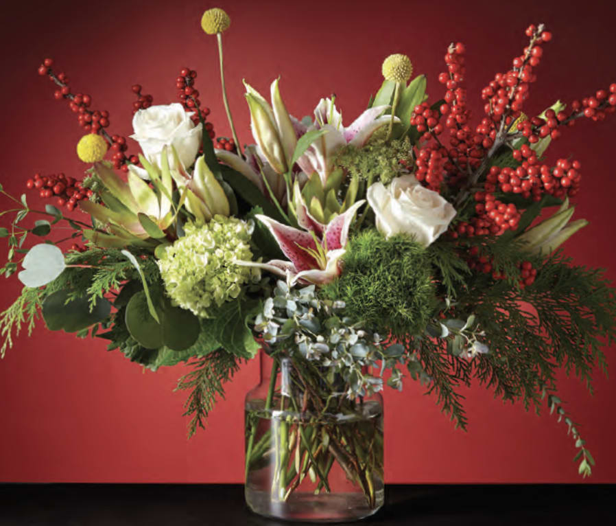 Mixed bouquet of white roses and lilies in a glass vase