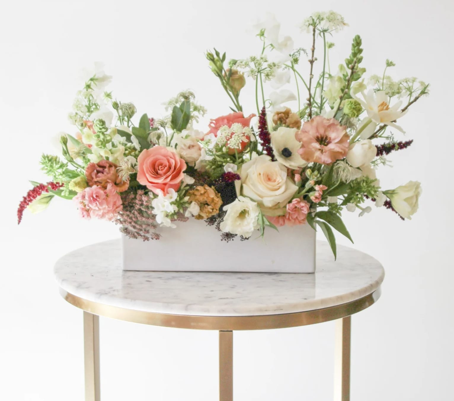 Mixed floral arrangement in a white rectangular box