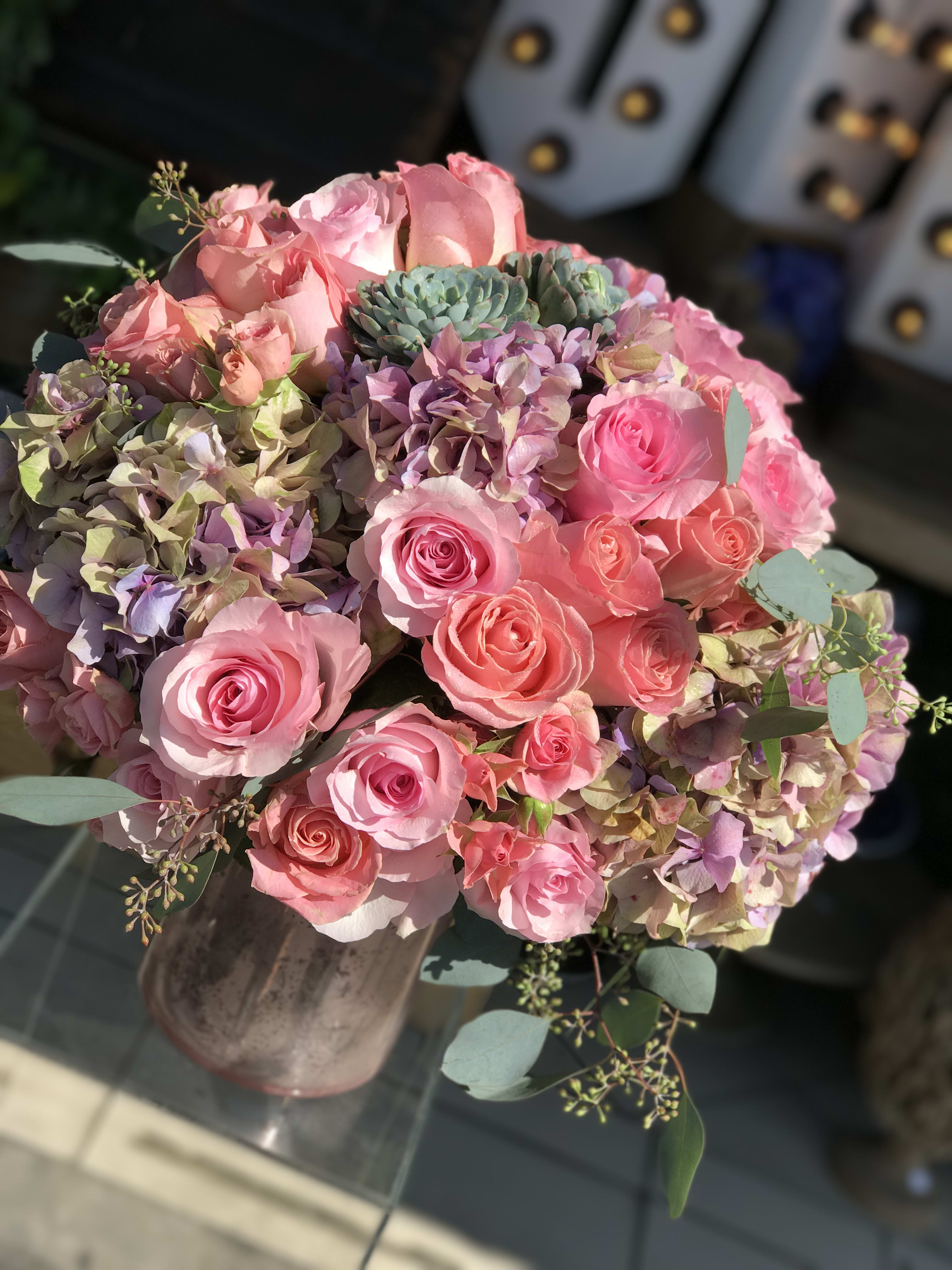 Mom's Favorite - Gold glass cylinder nicely arranged with roses and hydrangeas accented with small, green succulent