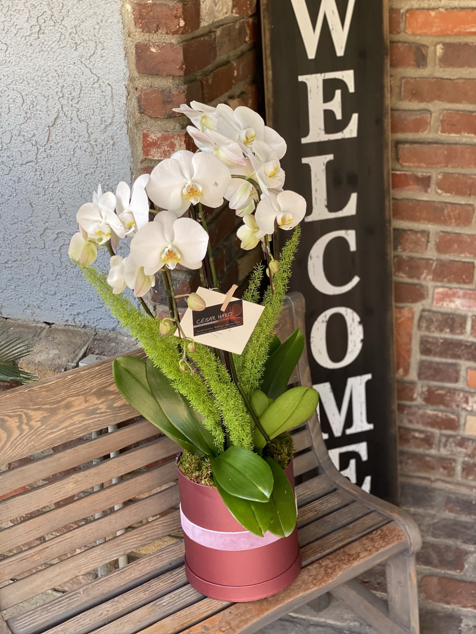 Simple &amp; Cute - Cardboard flower box with elegantly designed orchids and greenery decorations.