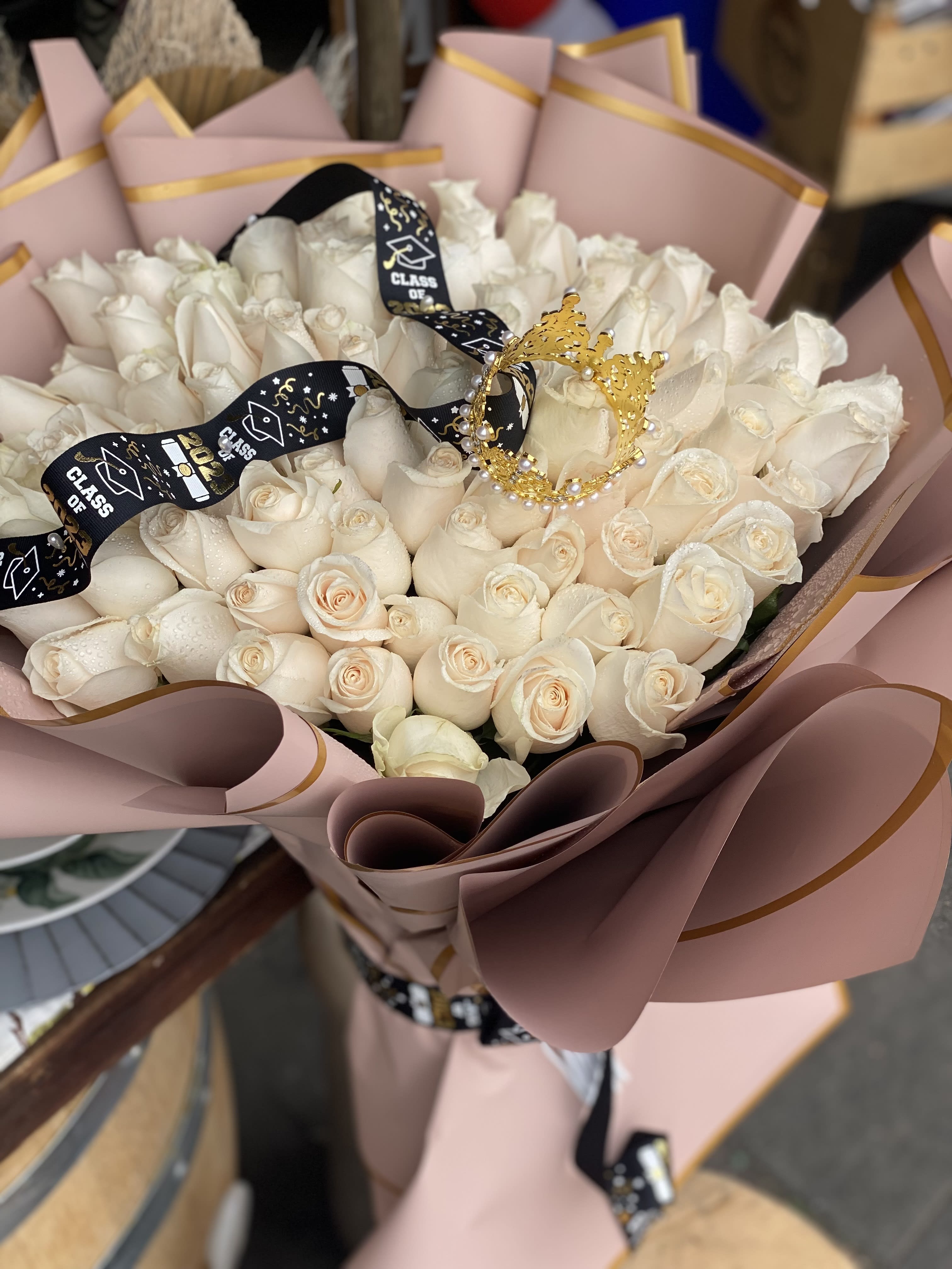Graduation Bouquet - 100 White/Cream Roses Floral Bouquet for that Special Grad beautifully wrapped in fine paper. *Please inquire roses available in other colors