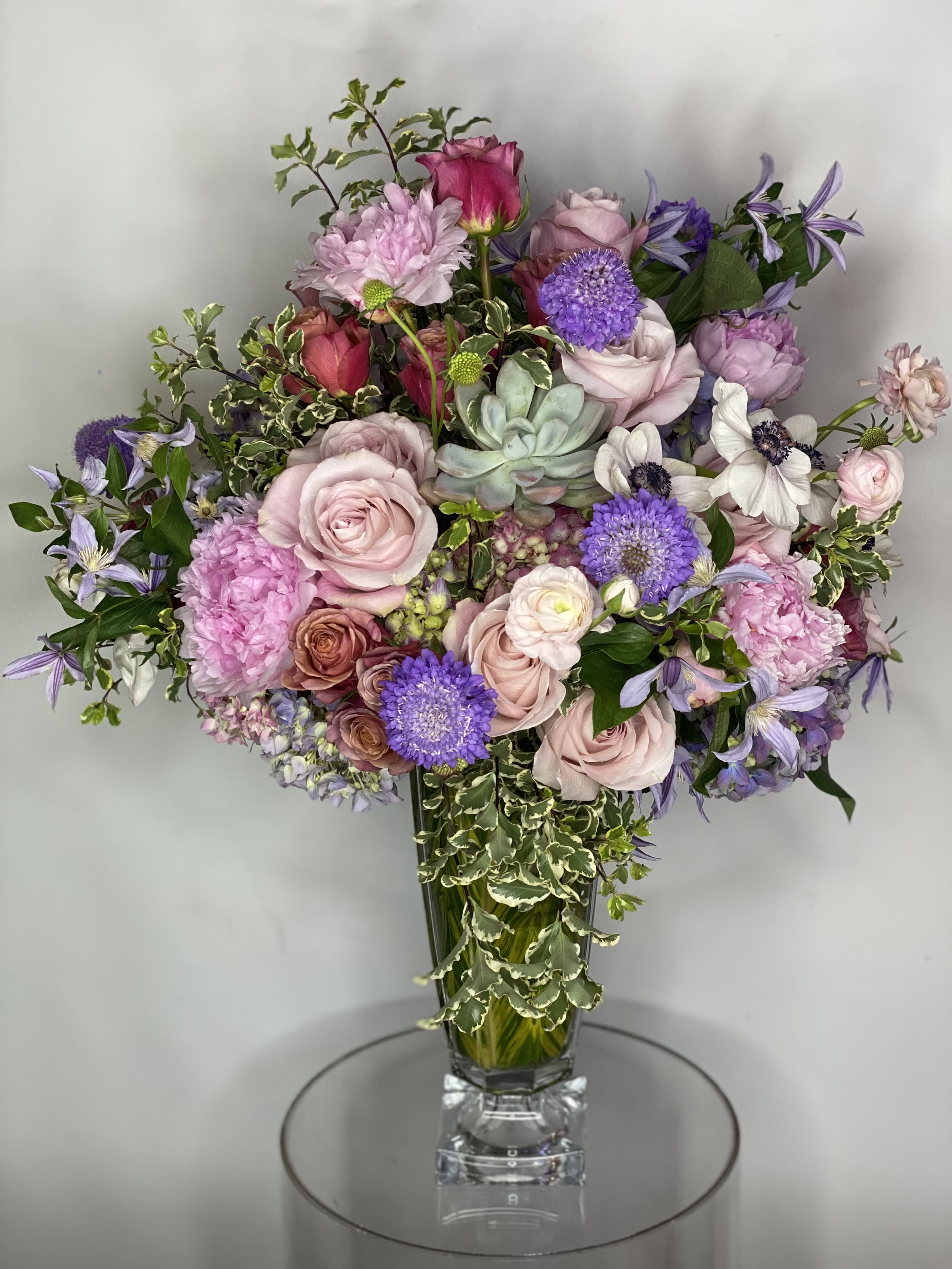 Happiness  - Excellent combination of different colors and flowers uniquely designed in a crystal glass vase 
