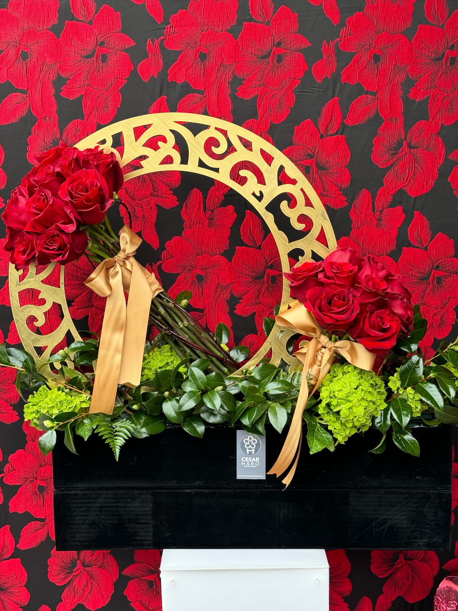 Gold Romantic Allure  - A luxurious and sophisticated arrangement of deep red roses nestled in a sleek black box, adorned with a shimmering gold circle. This elegant design combines the bold beauty of rich red roses with the refined charm of gold accents, symbolizing timeless love and opulence. The black box enhances the striking contrast of the red blooms, while the gold circle adds a touch of glamour and exclusivity. Perfect for celebrating love. 
