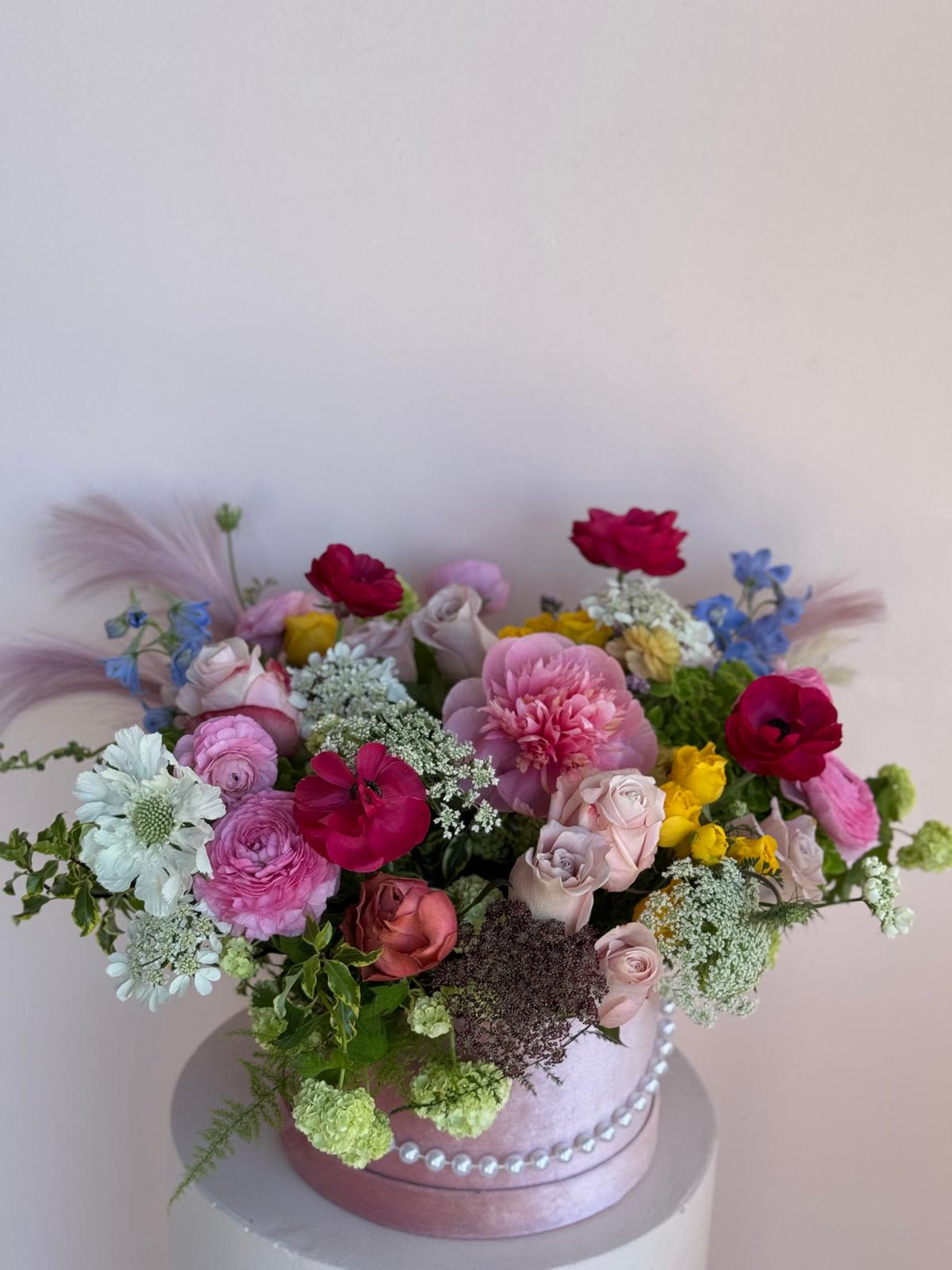Garden Of Pearls - A soft, romantic arrangement where blush-toned flowers bloom among shimmering pearl accents—evoking a secret garden touched by elegance and quiet luxury.