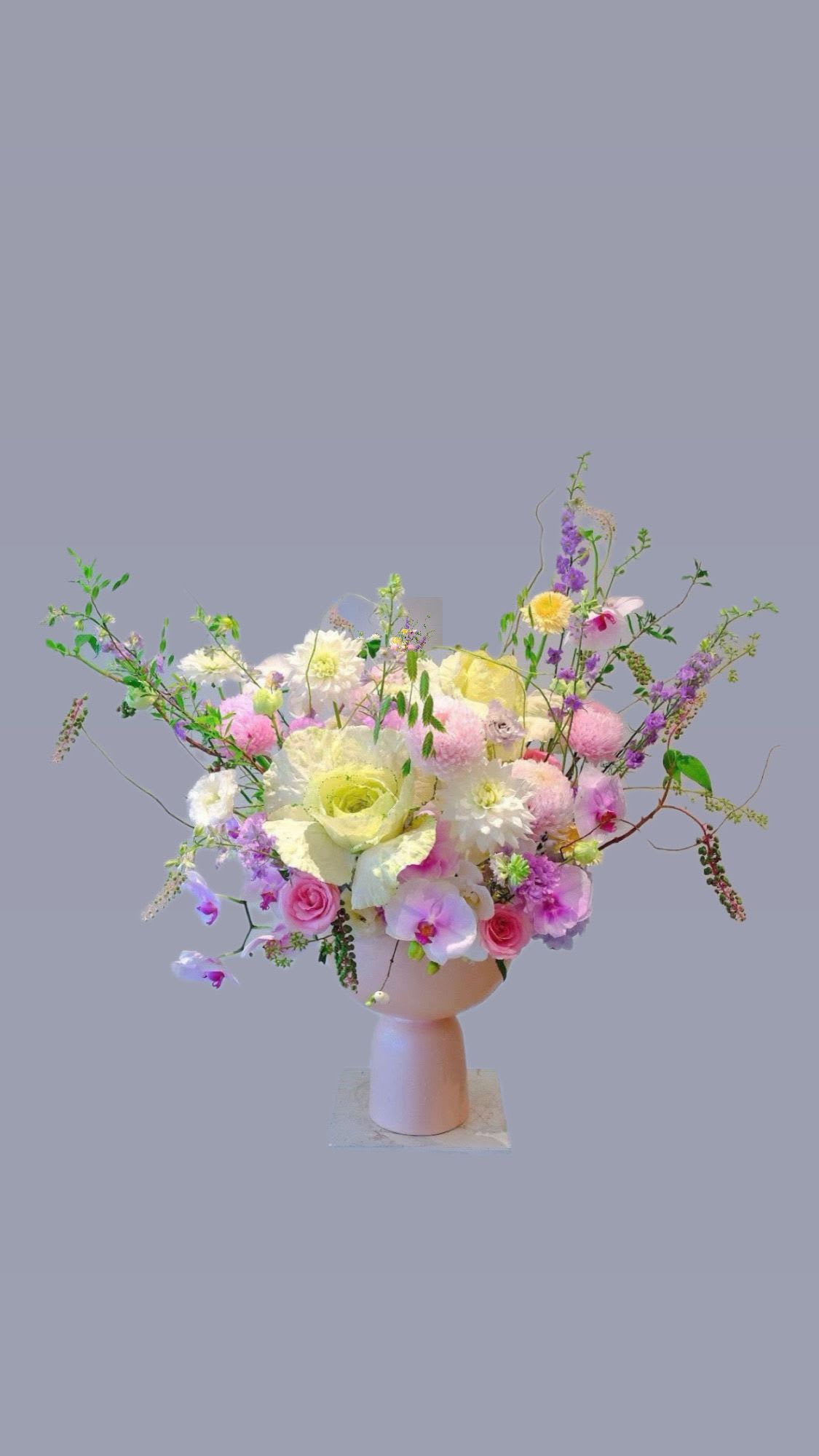 Fairy Bloom - A magical fusion of classic romance and forest whimsy — soft roses and rich assortments of flowers encircle a charming porcelain mushroom vase, evoking the enchantment of a woodland fairy bloom. 