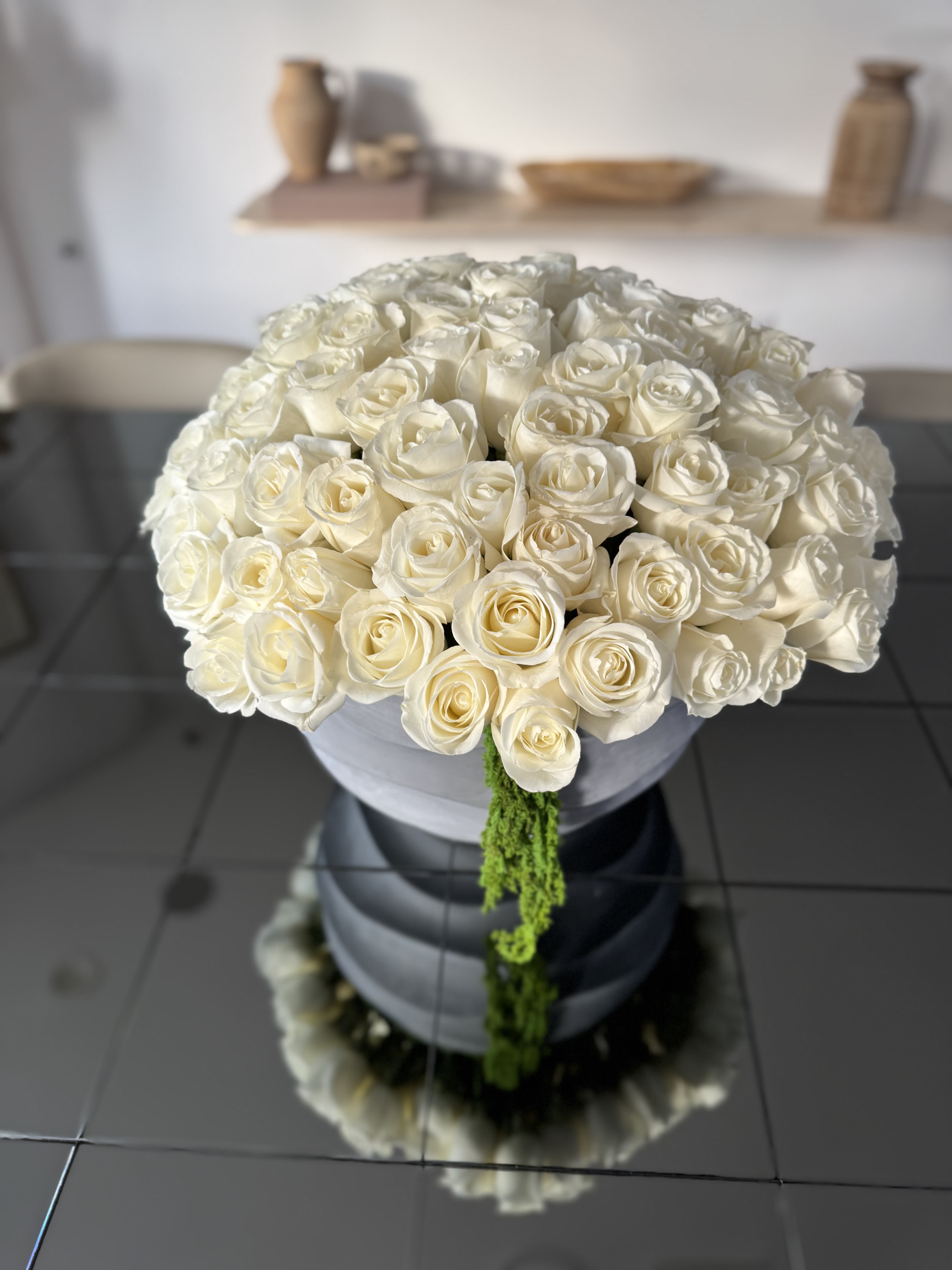 White Elegance  - Pure white roses in a concrete vase, filling the space with structure, strength and purity.