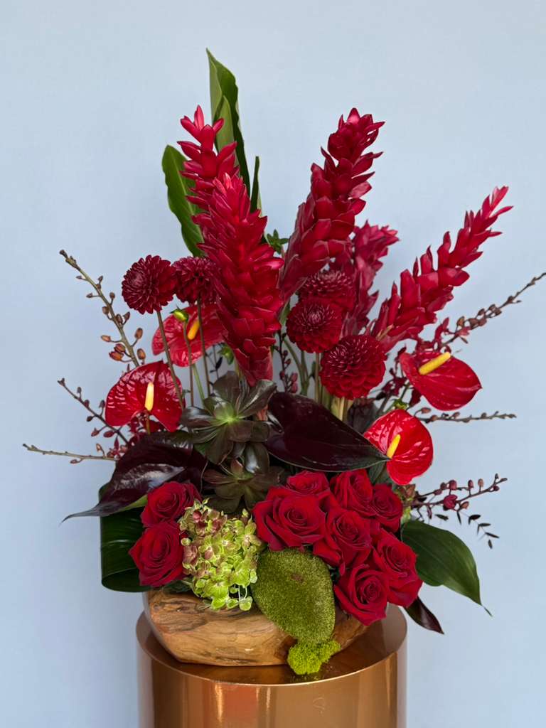 Si Te Quieres Divertir - That Caribbean Latin fun, that fills the air with endless possibilities. Romantic Red roses, passionate tropical flowers,  succulents, strong wood base and poetic flowers fill this arrangement with desire. 