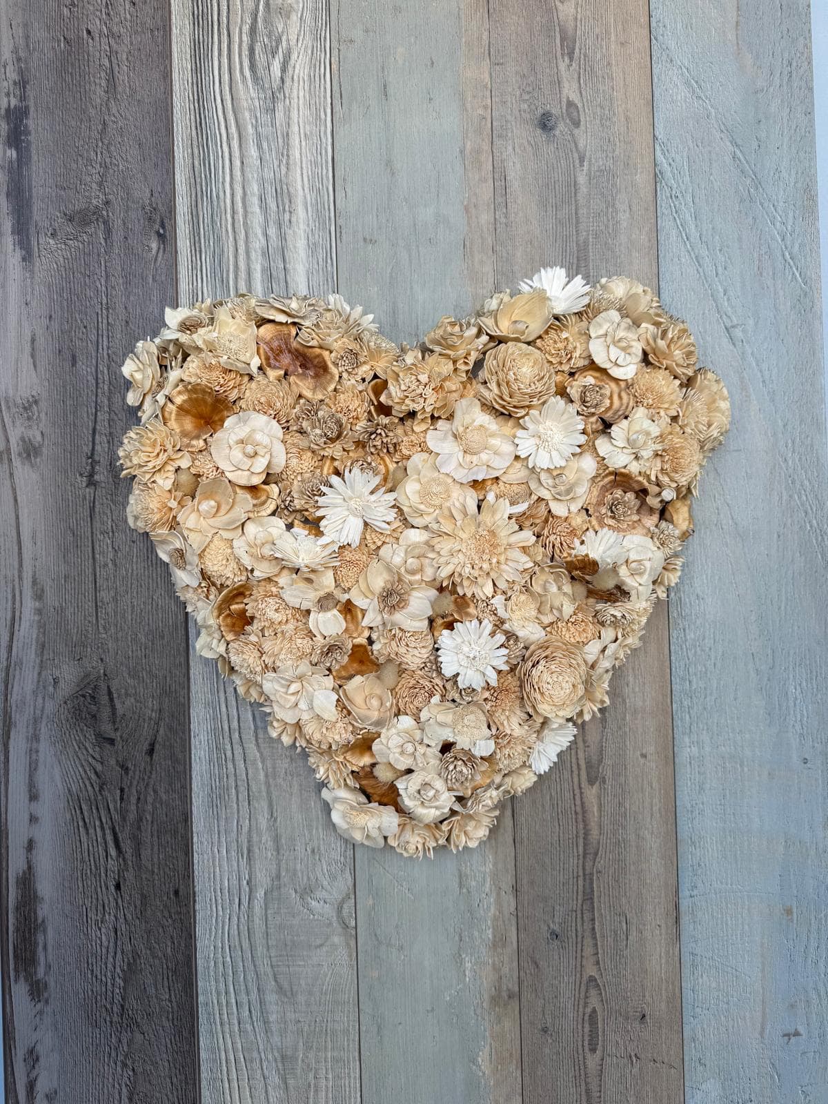 Hand crafted Art  - A dried flower heart mounted on 30×50 wood planks, creating a stunning statement piece full of warmth and love. The natural textures and preserved blooms bring timeless charm and rustic elegance to your wall—perfect for adding a heartfelt touch to any space. 
