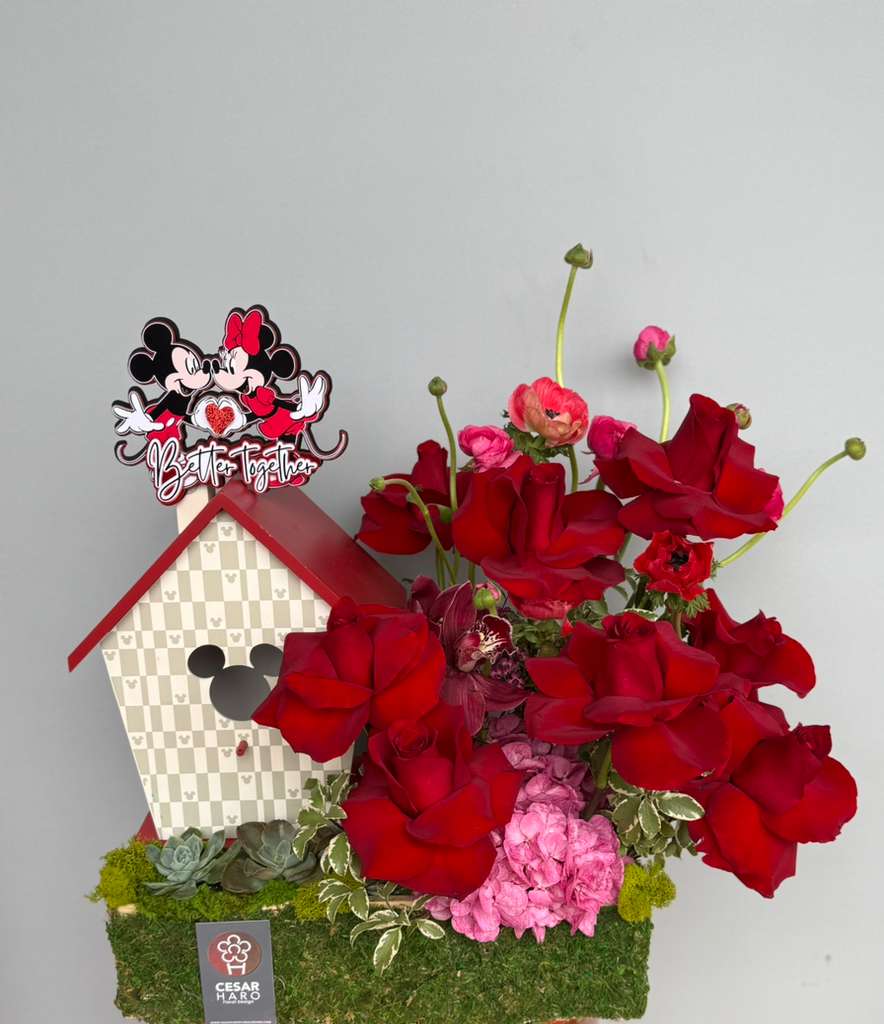 Mickey &amp; Minnie Love Affairs - Romantic red roses paired with delicate ranunculus and bold anemones, beautifully styled with charming Mickey &amp; Minnie love shack accent-playful yet passionate. 