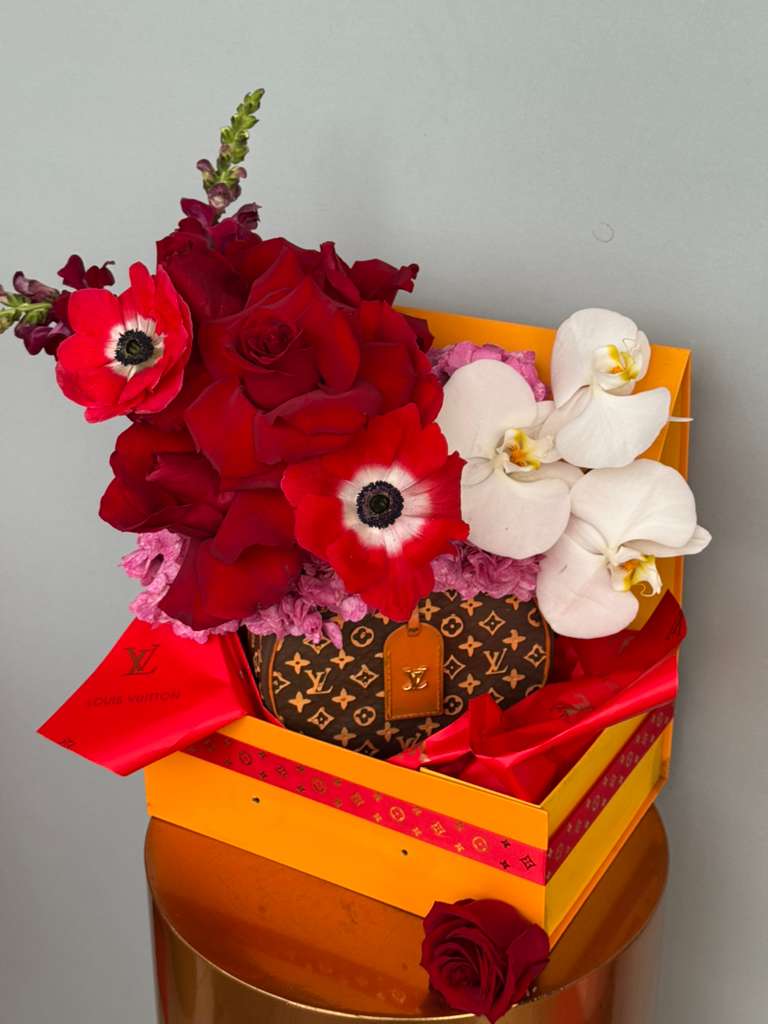 Mon Amour Designer Charm  - Elegant red roses paired with graceful blooms beautifully arranged in a designer-inspired Louis bag/box. 