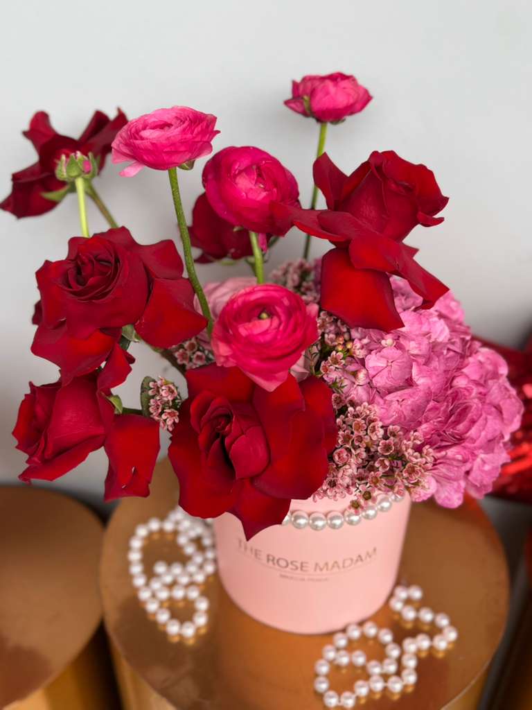 Pleasure in Pink  - Roses, ranunculus and hydrangeas in the perfect velvet box with a string of pearls. 