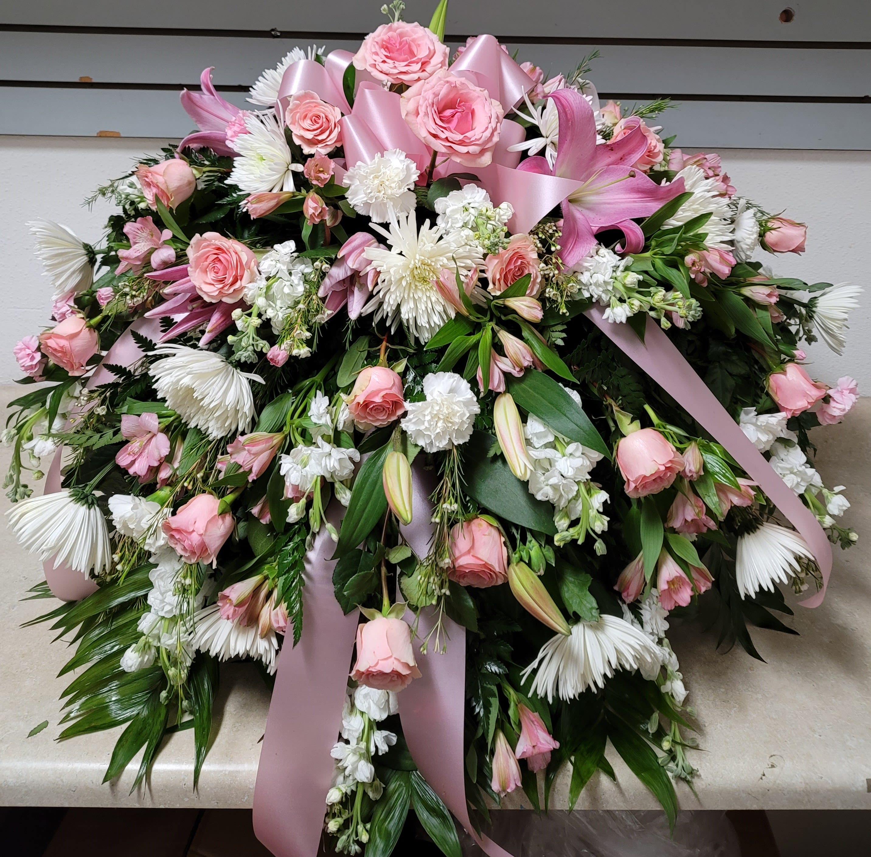 Large pink and white floral spray with ribbon accents