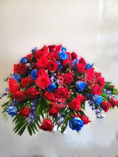 Large bouquet of red and blue roses with red accent flowers