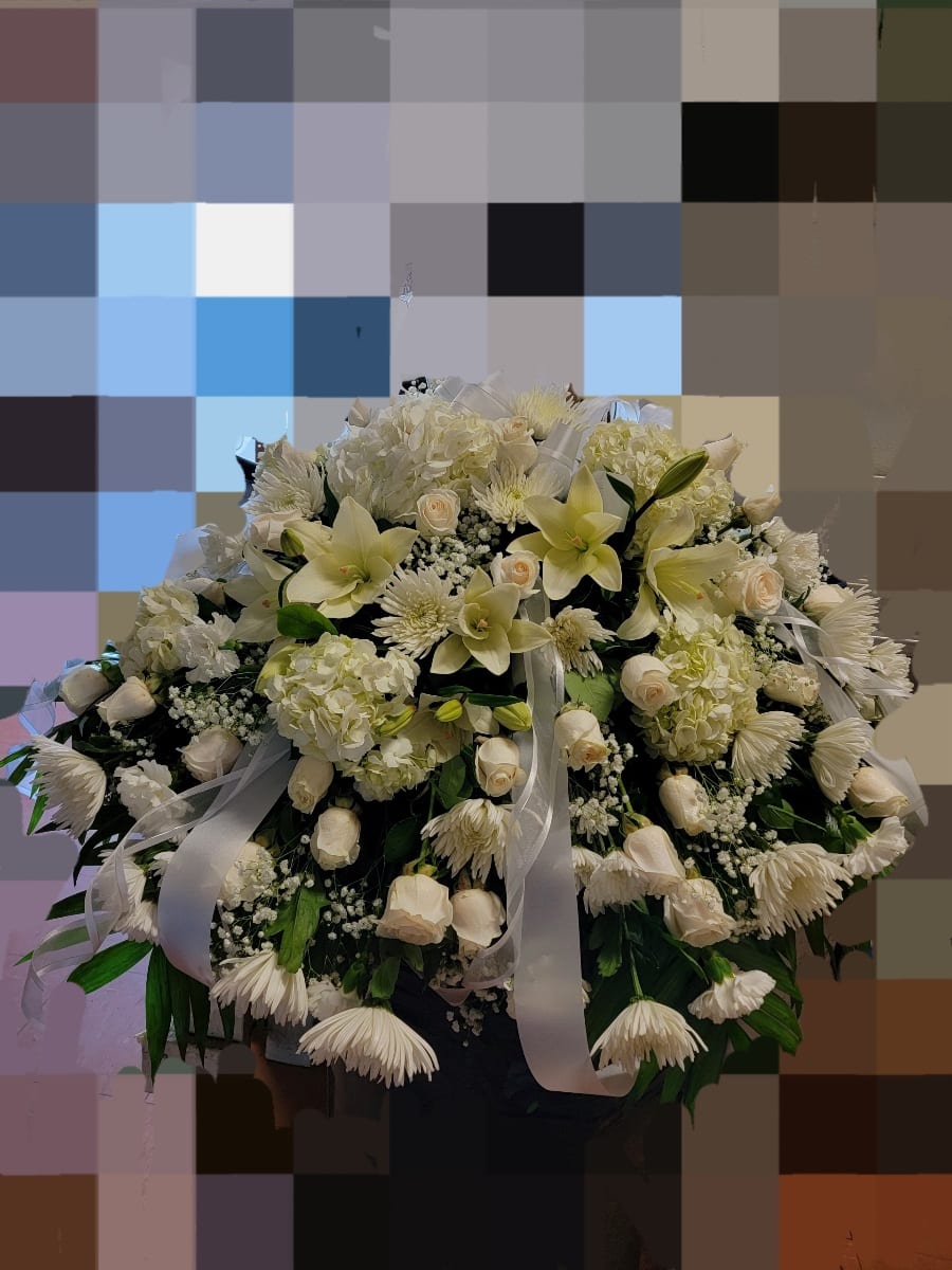 Large white floral arrangement with lilies, roses, and chrysanthemums