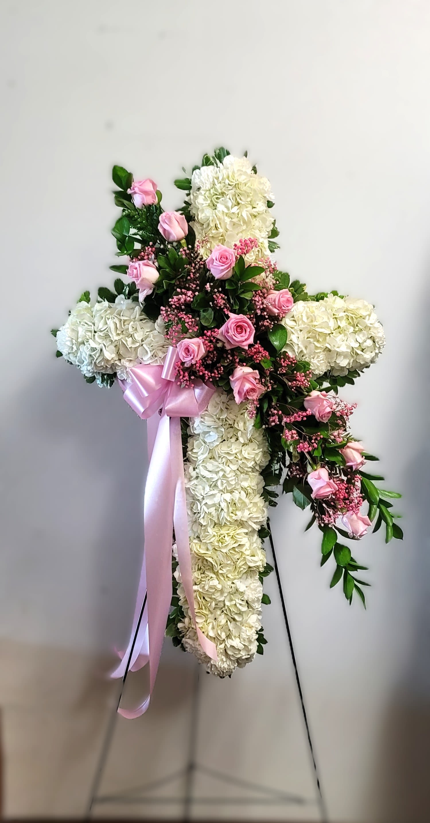 Cross-shaped floral standing spray with pink roses and white hydrangeas