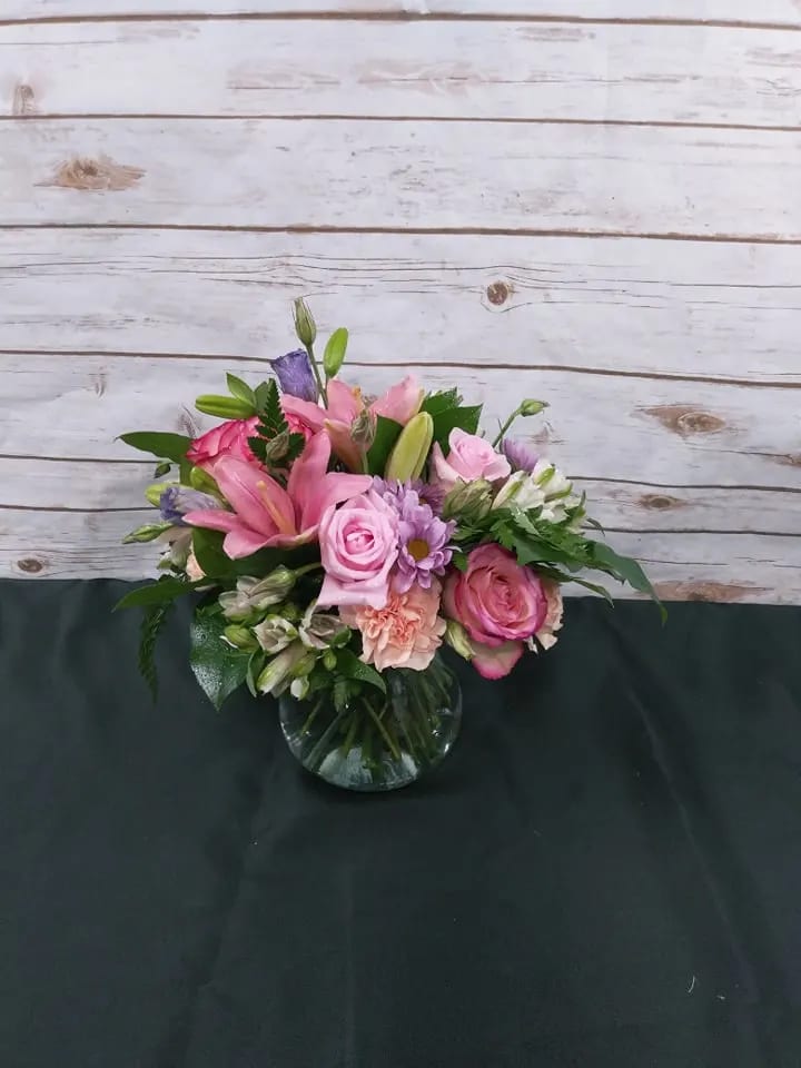 Pink and purple mixed bouquet in a glass vase