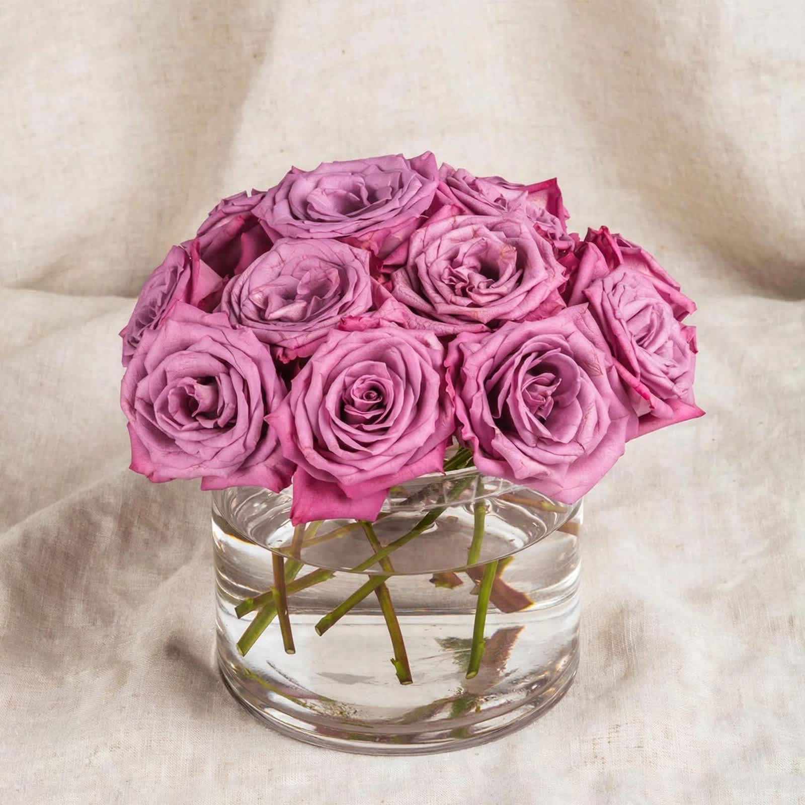 Pink roses arranged in a clear glass vase