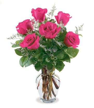 Pink roses arranged in a clear glass vase