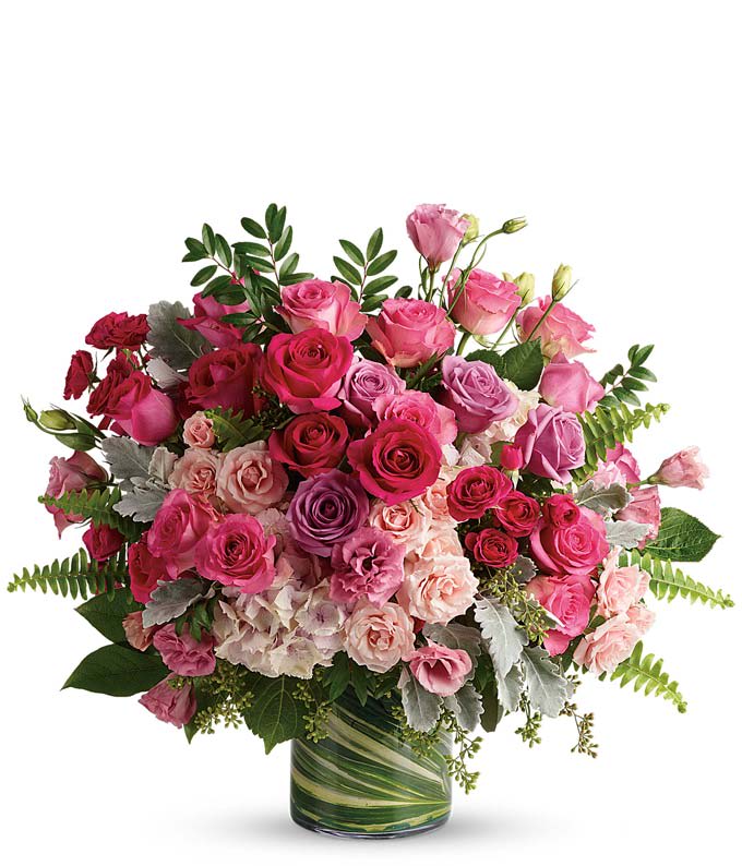Pink and lavender rose bouquet in a glass vase