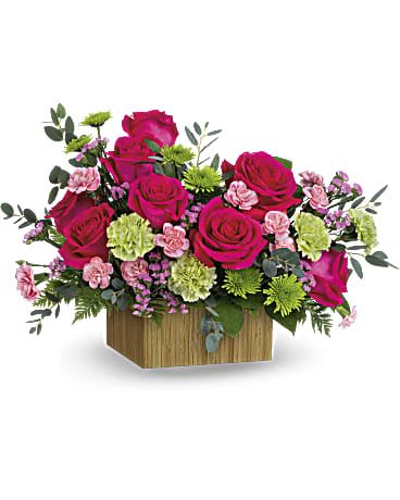 Pink rose arrangement in a wooden box with green and lavender accents