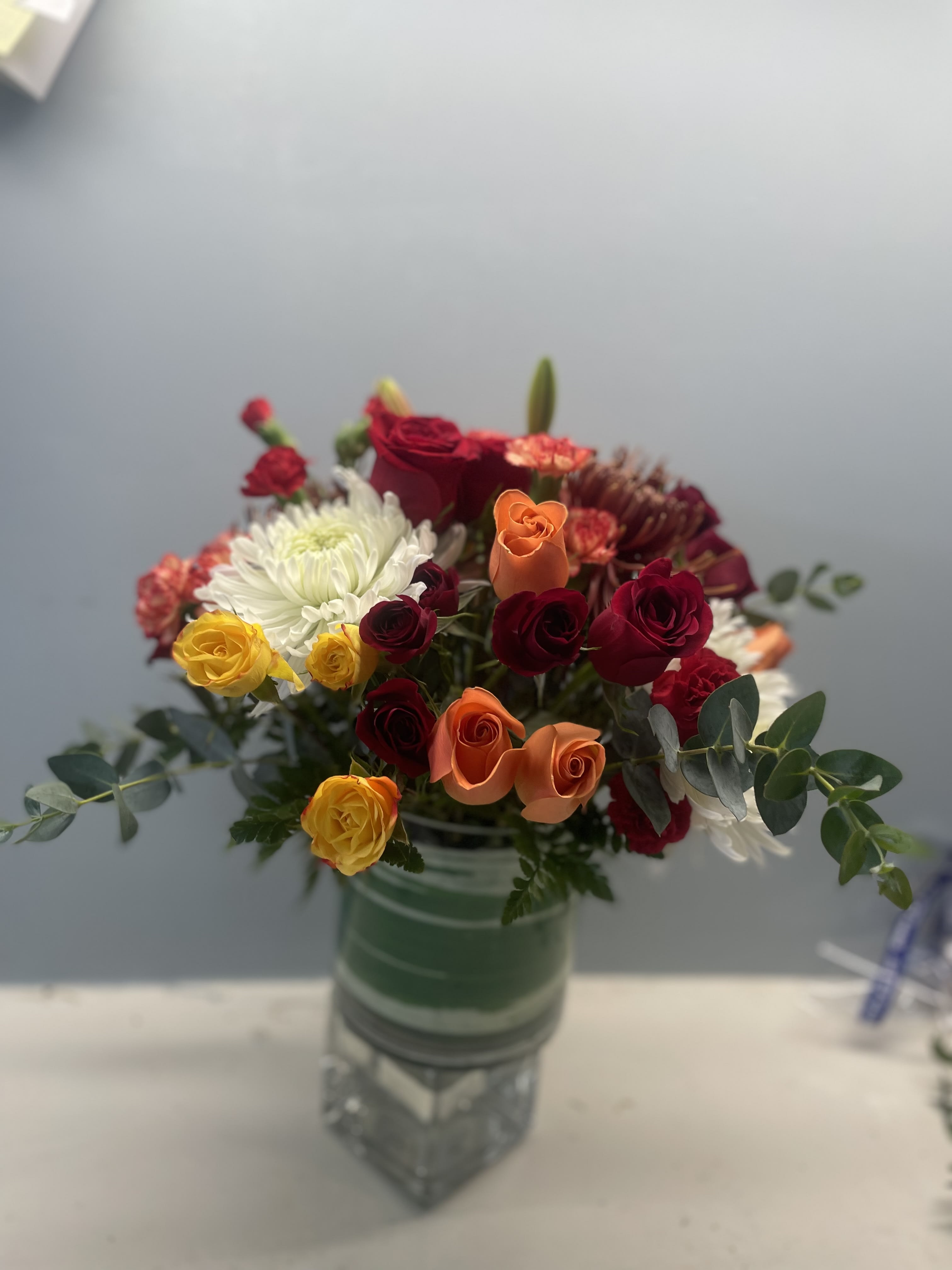 Modern thanksgiving  - A lush low cylinder  vase overflowing with thanksgiving blooms