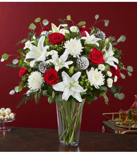 Red roses and white lilies in a clear glass vase