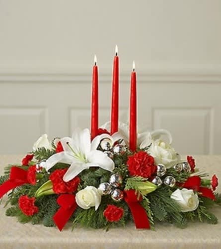 Red and white floral centerpiece with three red candles