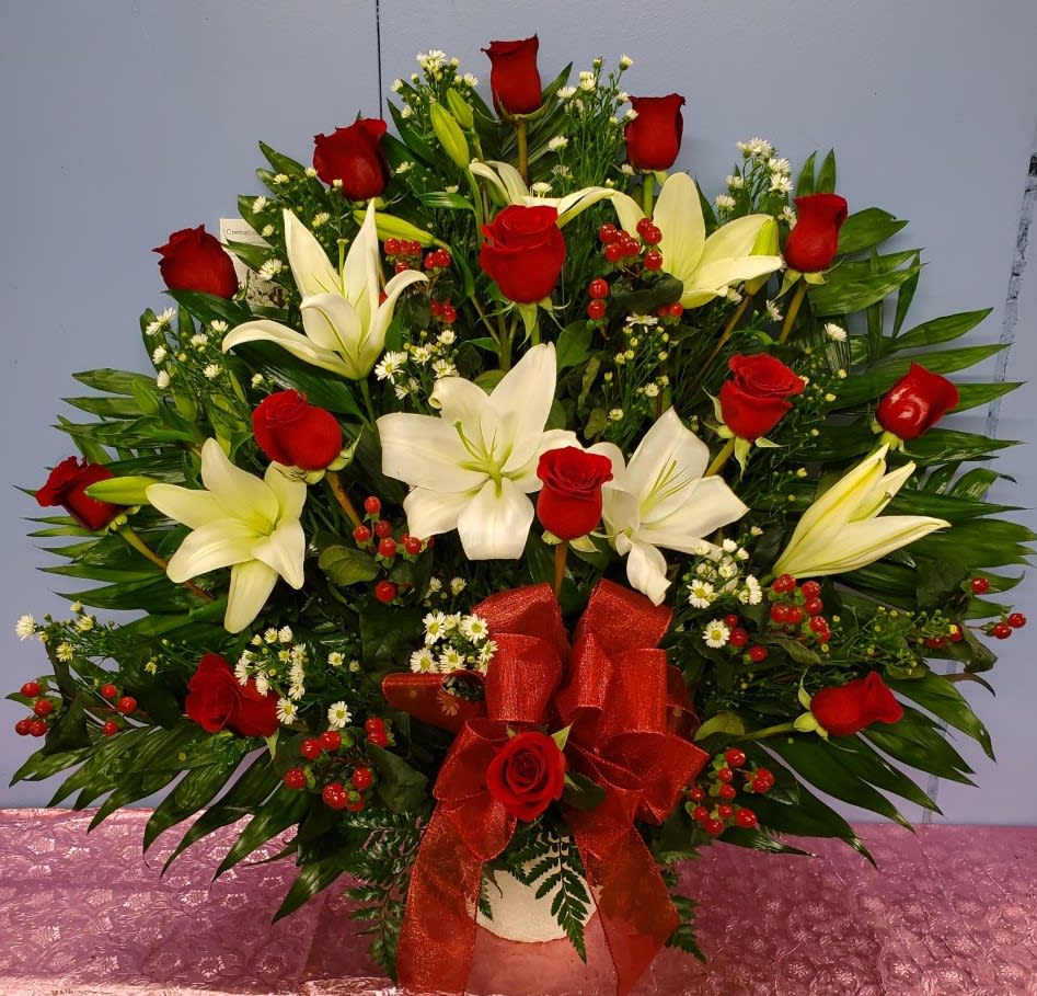 Large bouquet of red roses and white lilies with a red ribbon