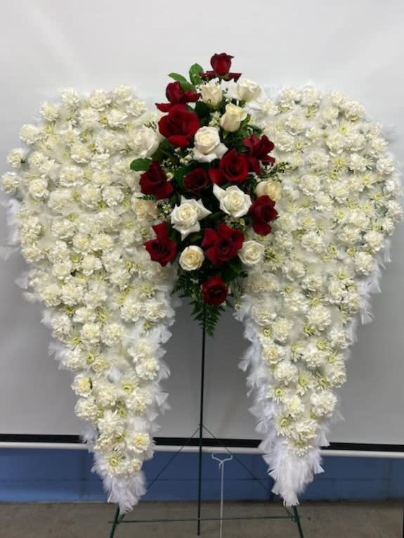 Standing floral spray with red and white roses surrounded by white flowers