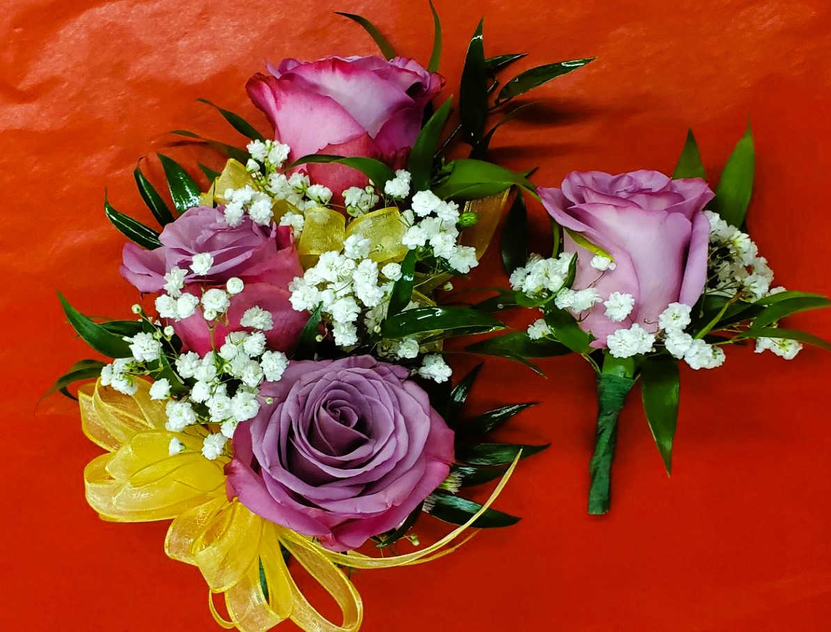 Purple rose boutonnieres with baby's breath and yellow ribbon