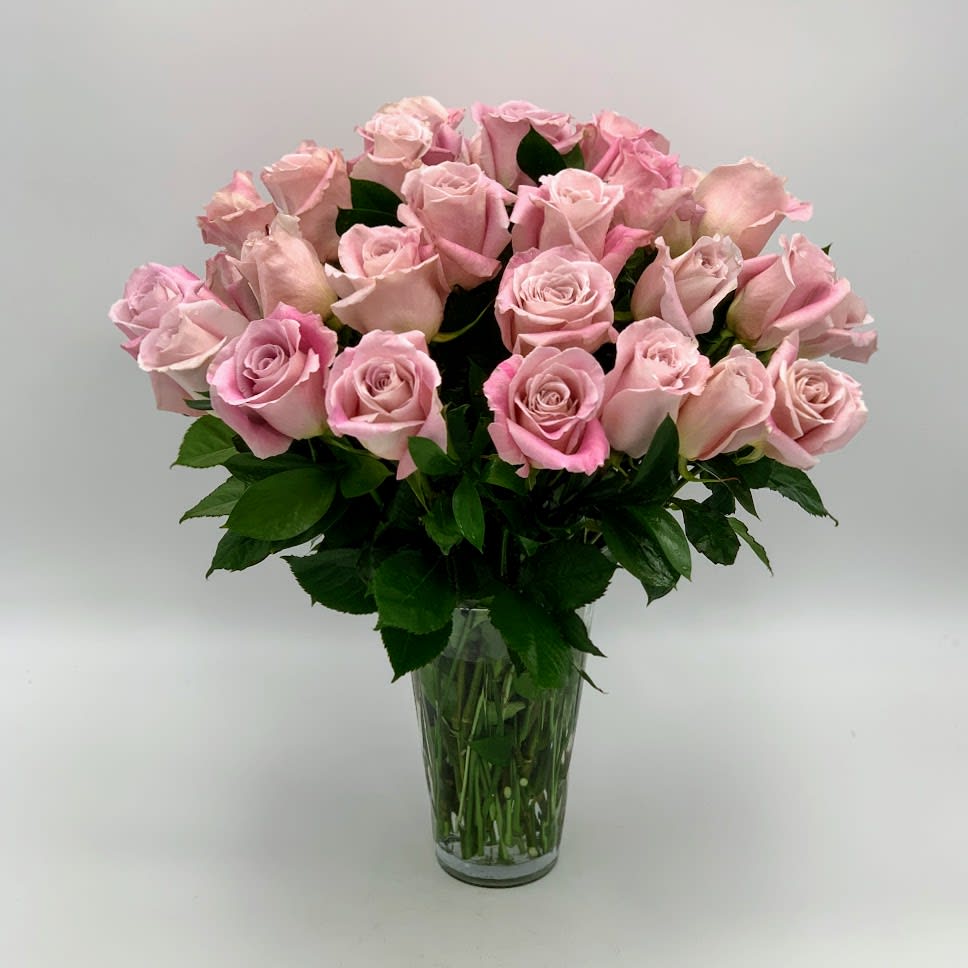 Pink roses arranged in a clear glass vase