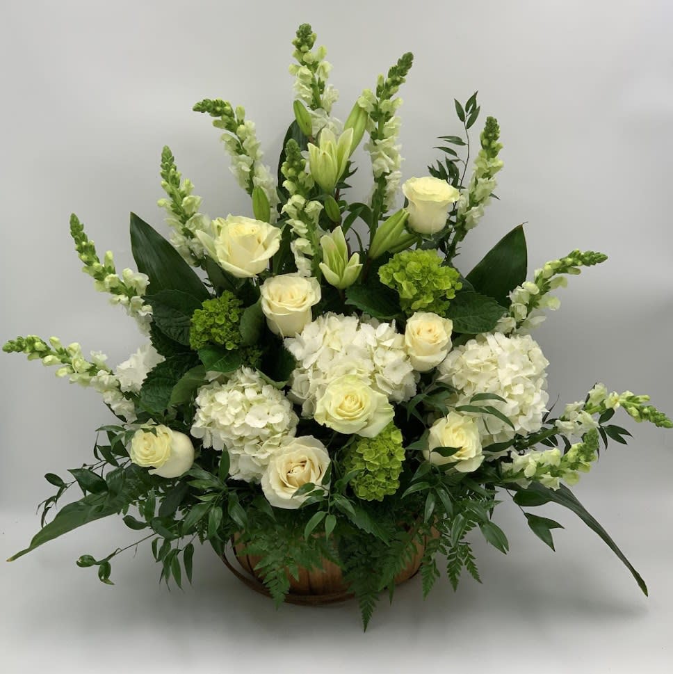 White roses and hydrangeas arranged in a low bowl