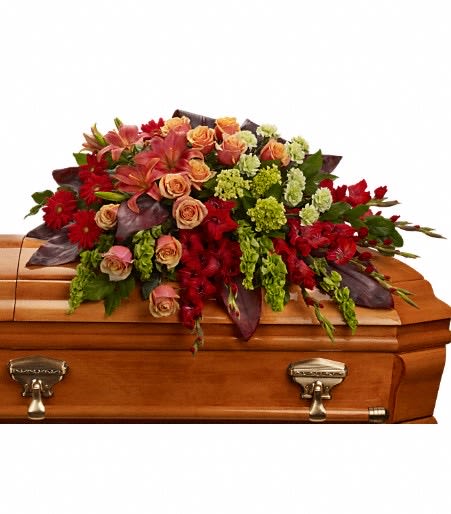 Casket spray with red, peach, and green flowers