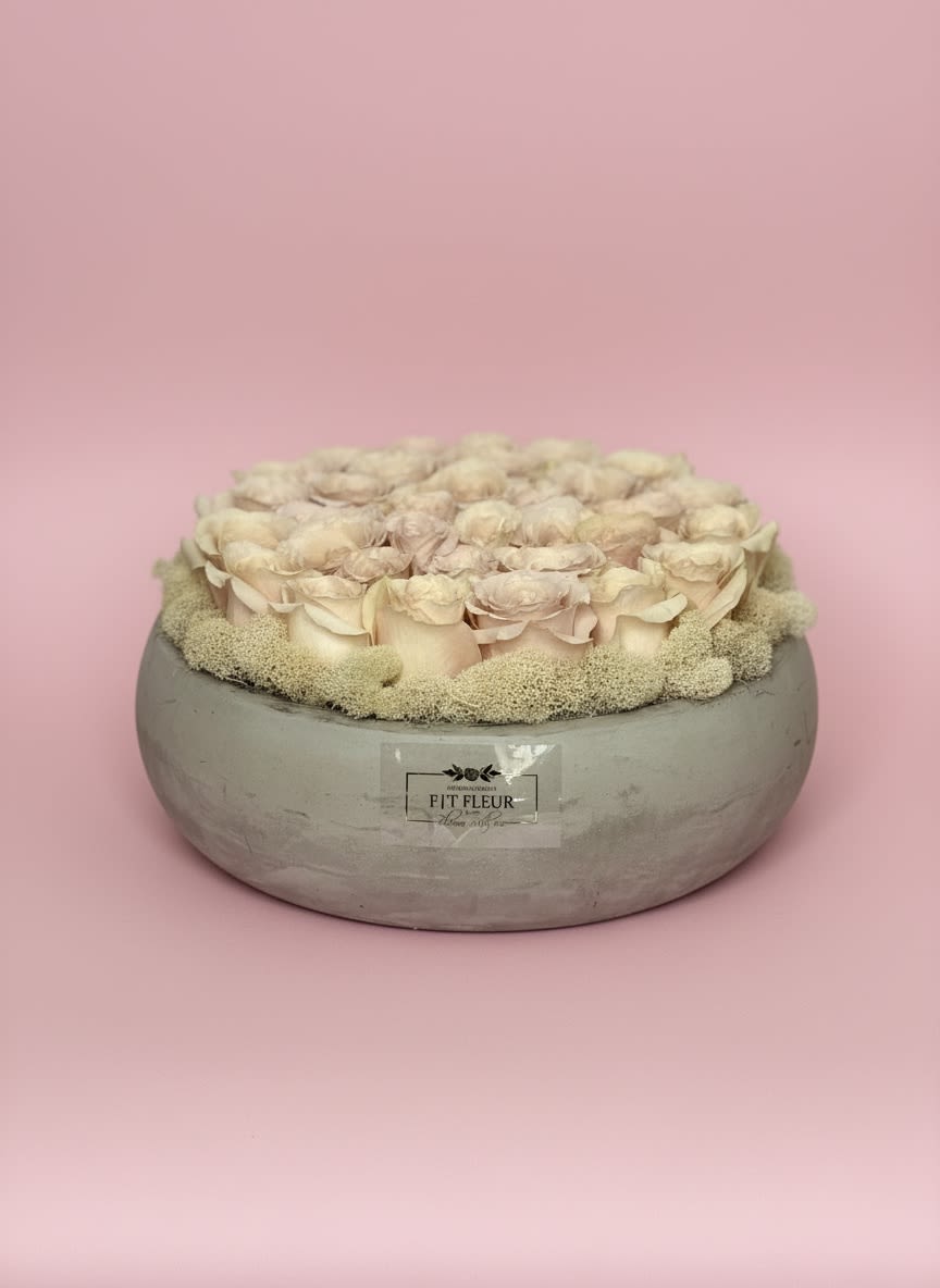 Ivory Whisper Rose Bowl - A timeless arrangement of premium ivory garden roses, artfully nestled in a modern concrete bowl and accented with soft preserved reindeer moss. Its delicate neutral palette brings effortless elegance and tranquility, making it a beautiful gift for birthdays, anniversaries, sympathy, housewarmings, or simply to brighten someone’s day. Designed with a luxurious garden-inspired feel, this piece complements both modern and classic interiors.