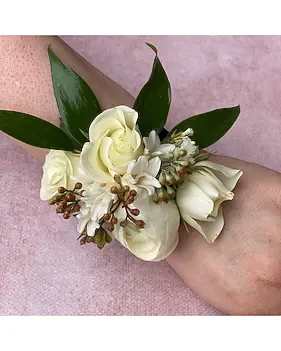 White + Green Wrist Corsage - Add a touch of natural elegance to your special occasion with this beautifully handcrafted wrist corsage. Featuring delicate white blooms paired with fresh green leaves and subtle berry accents, this piece creates a soft, romantic look.