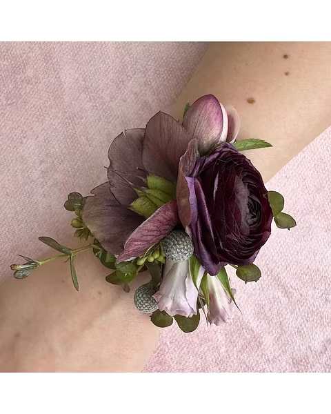 Purple Hues Wrist Corsage - Perfect for weddings, proms, engagements, or any formal event, this corsage is designed to sit comfortably on the wrist while making a stylish statement. Its timeless color combination complements a wide range of outfits and themes. 