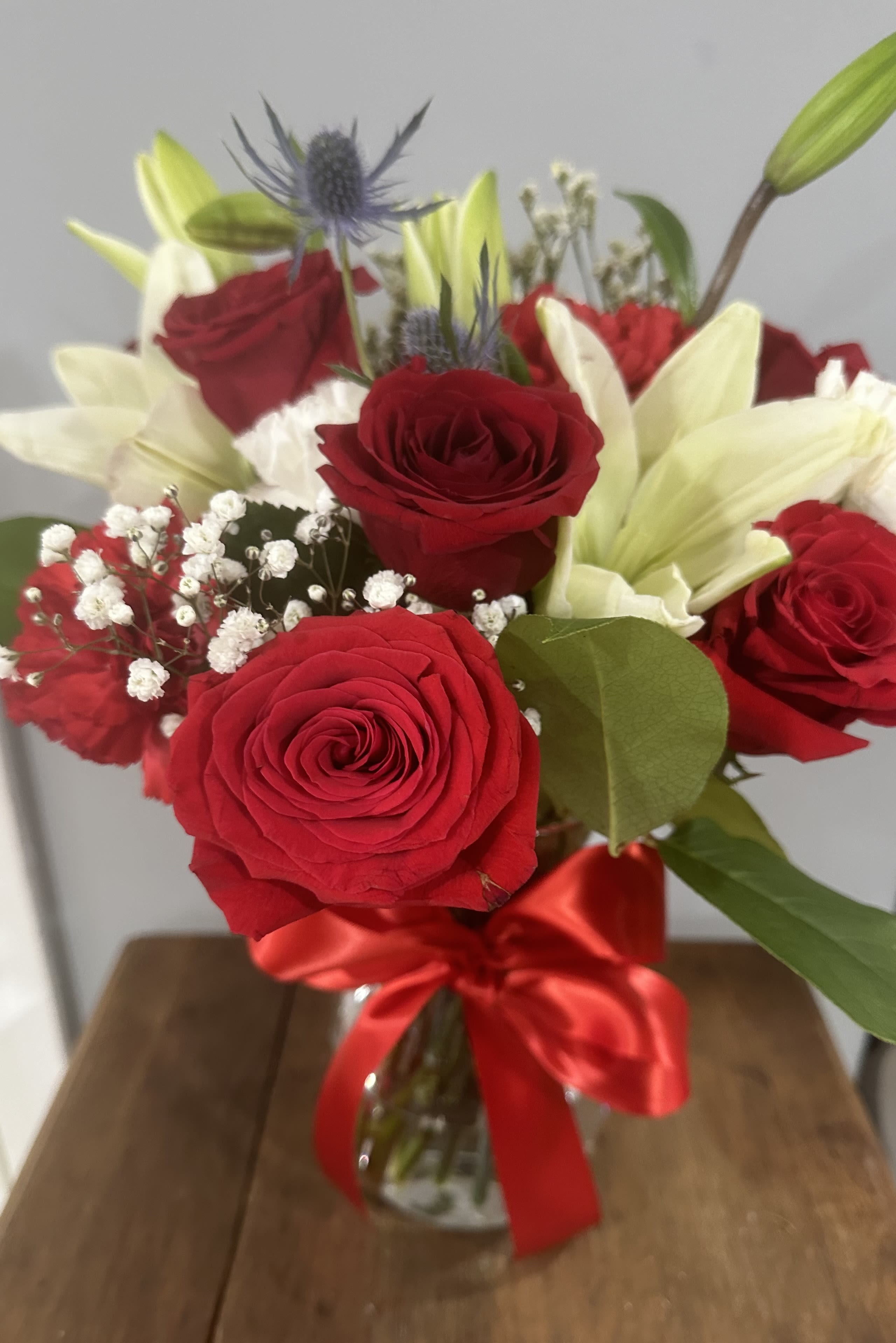 How Sweet It Is by Petals 2 Go - This pretty design of roses and lilys will surely make someone smile today.