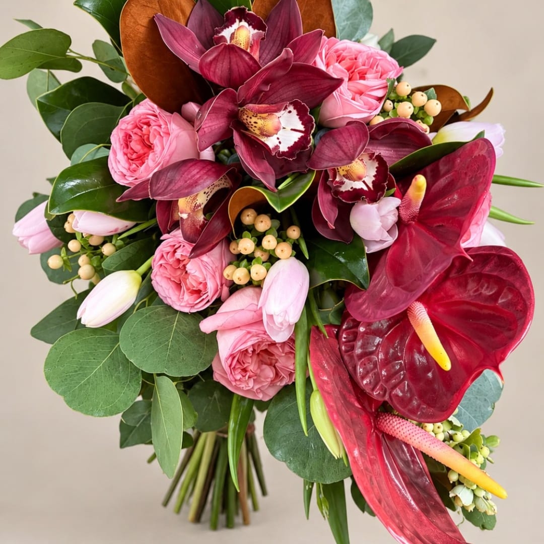 Bouquet of pink roses, burgundy orchids, and red anthuriums