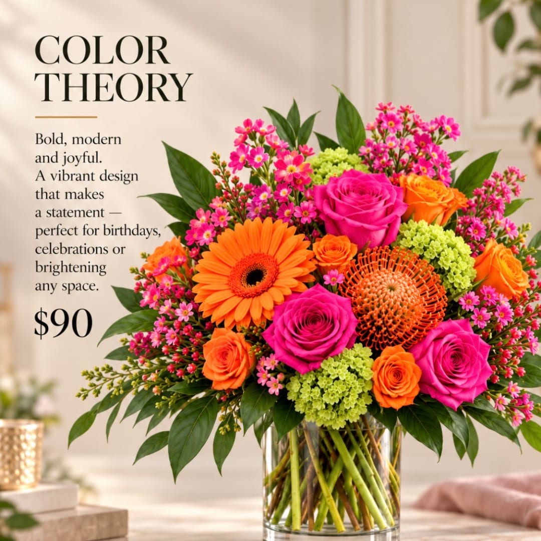Bright mixed bouquet in a clear glass vase with pink and orange flowers