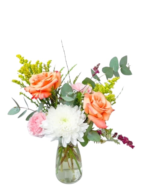 Peach roses and white chrysanthemum in a glass vase