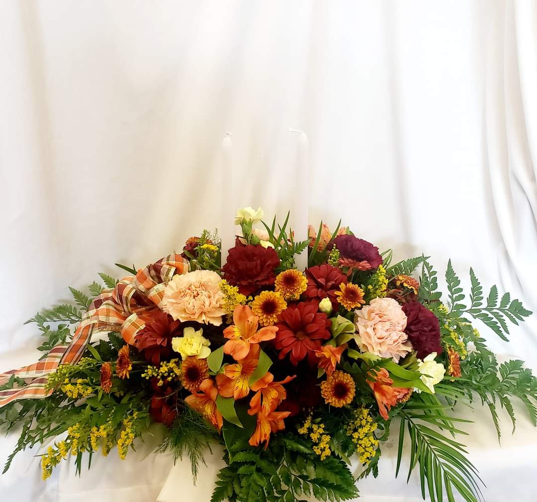 Thankful Blessings - Eye-catching Thanksgiving centerpiece with candles, carnations, alastromeria, mums, and daisies. 